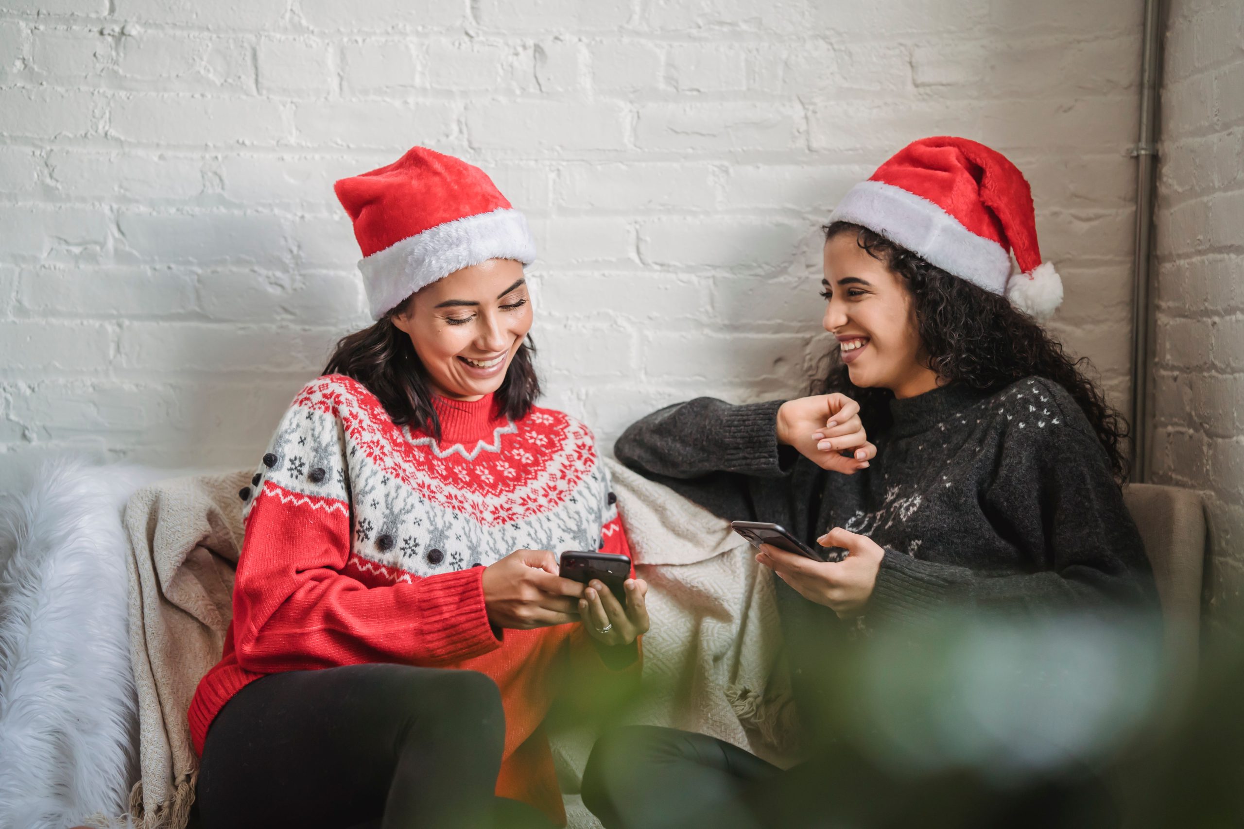 Amies riant en pull chaud pendant fêtes Noël