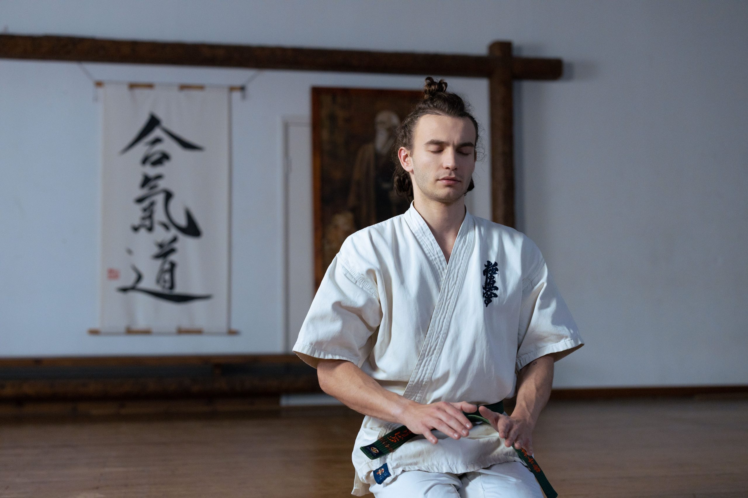Martial artist meditating peacefully in dojo